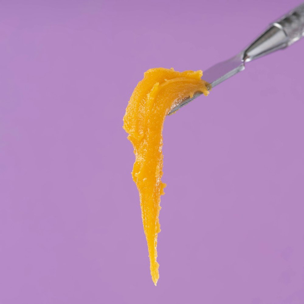 Golden cannabis concentrate on a dab tool