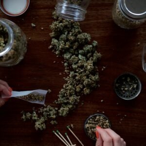Rolling papers, grinder and cannabis flower