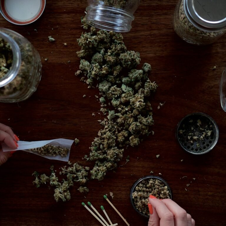Rolling papers, grinder and cannabis flower